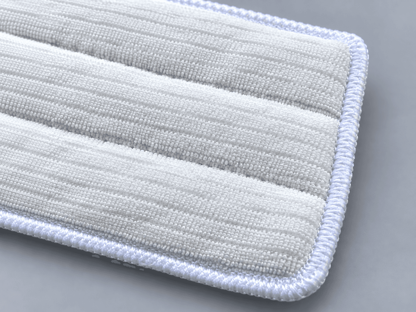 Polyester knit cleanroom mop, fibre and stitched-edge detail